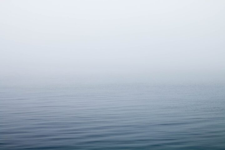 body of water under fog