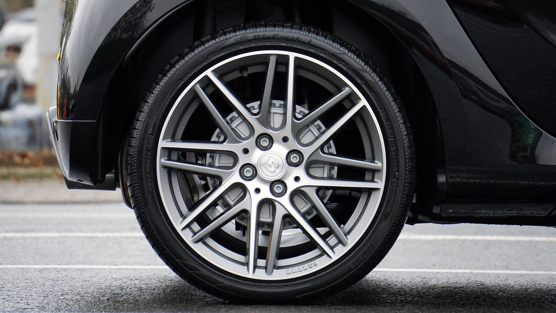 close up photograph of chrome vehicle wheel